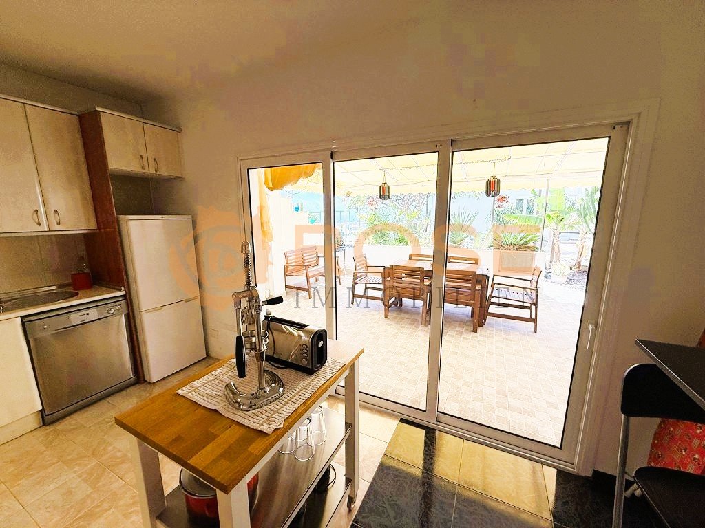 Kitchen with direct terrace access and large sliding doors to the outdoor area