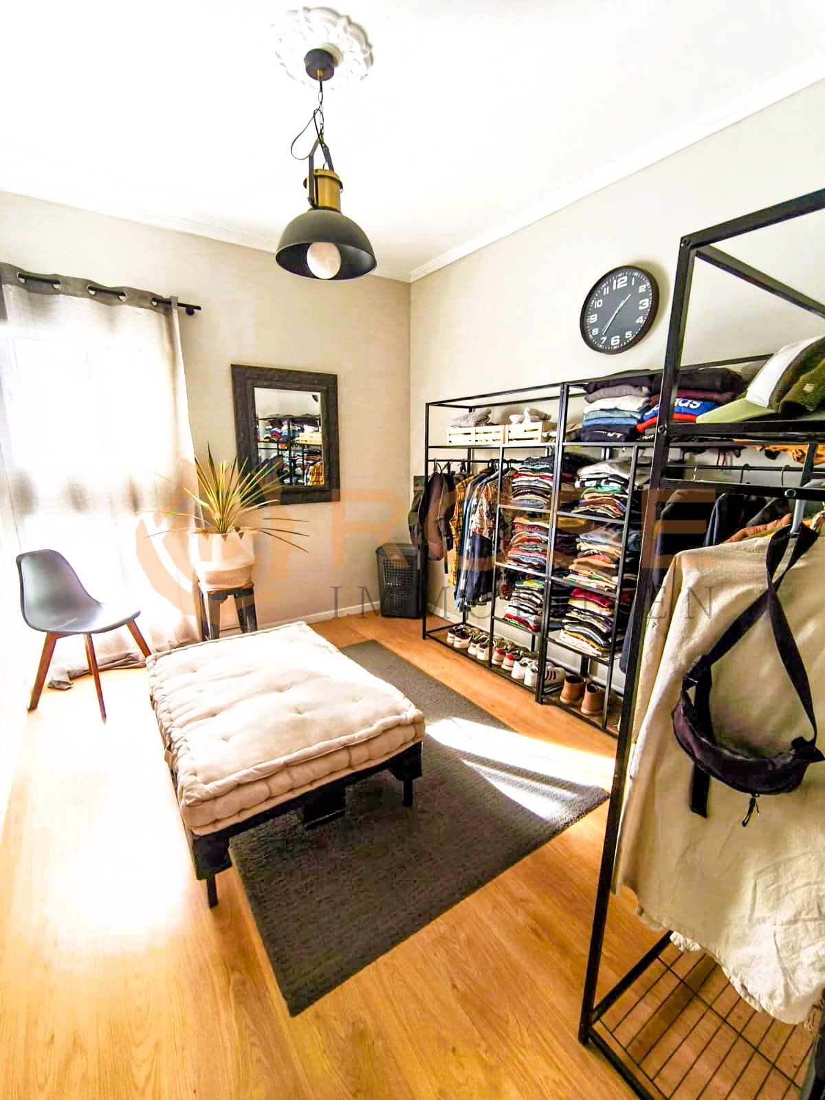 Walk-in dressing room with optimal storage architecture and natural lighting