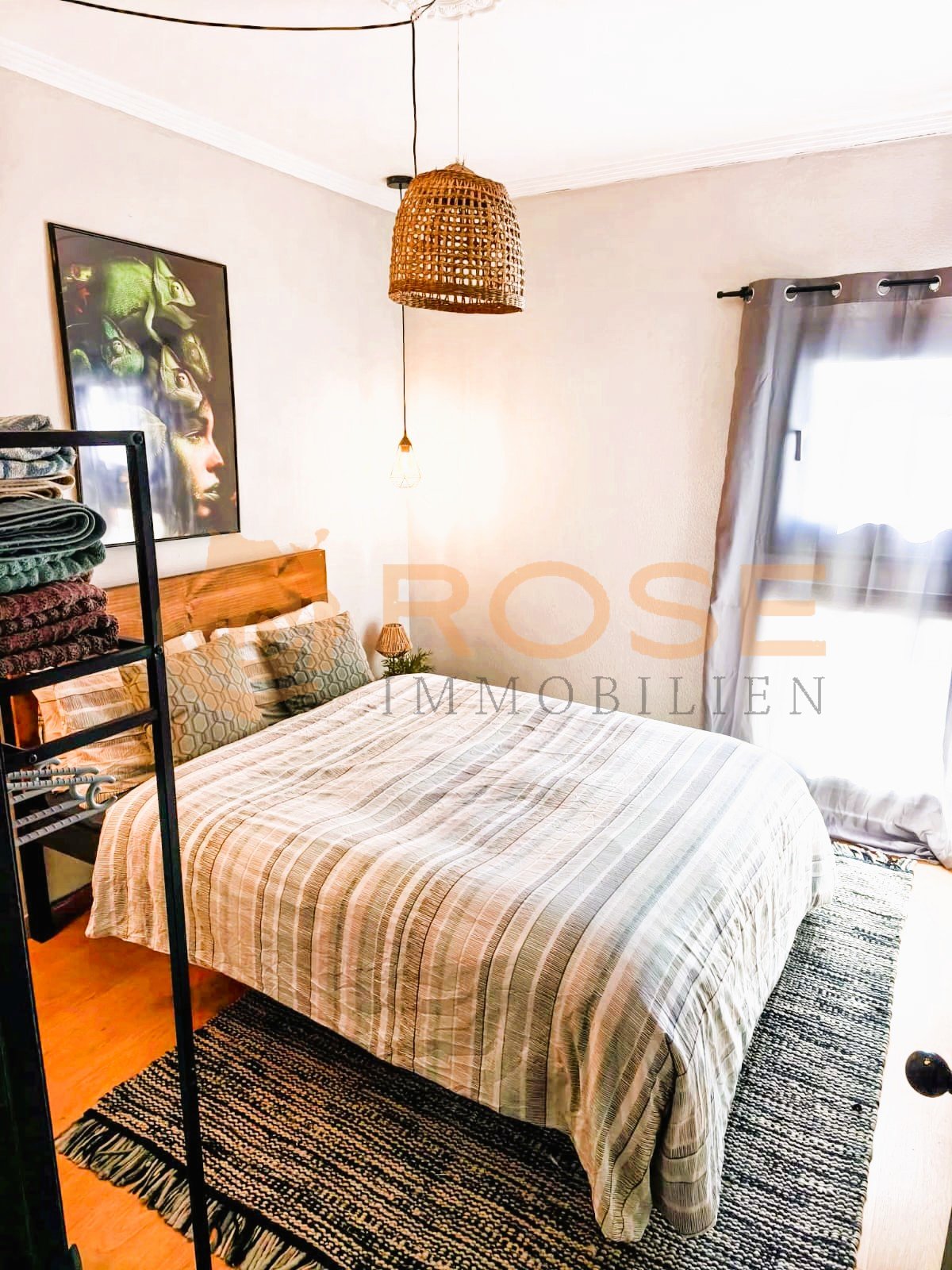 Bright bedroom with floor-to-ceiling window and practical dressing area
