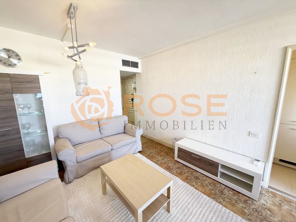 Bright living room with open layout and air conditioning