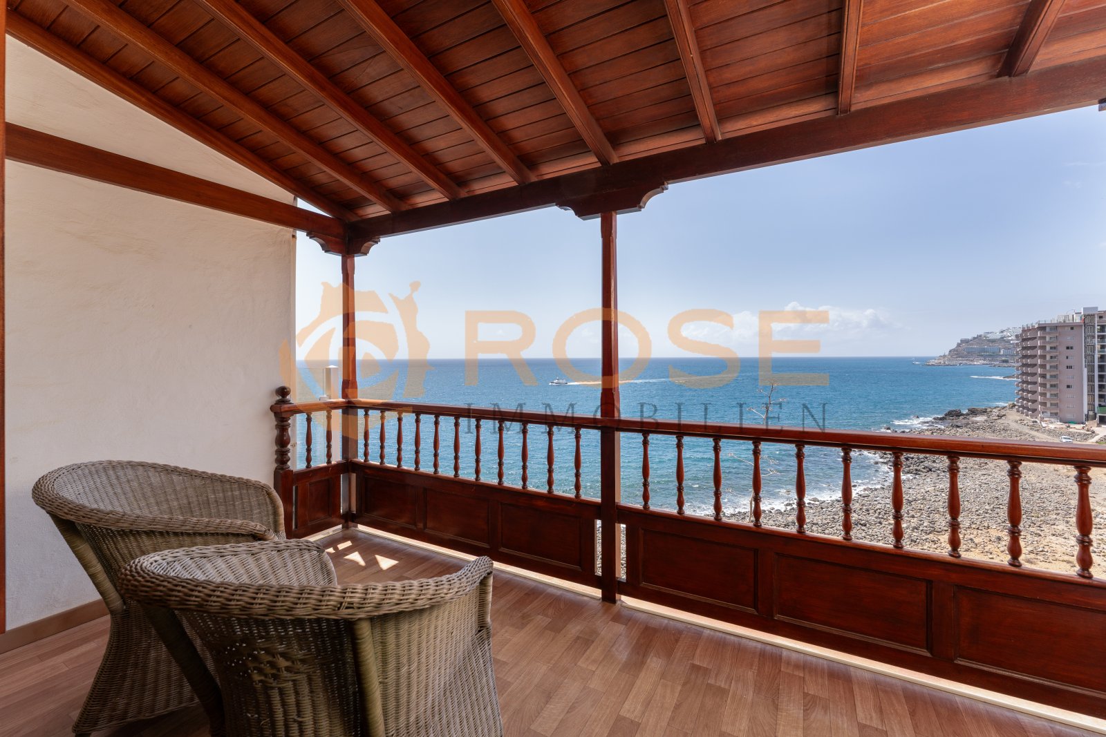 Covered terrace with sea view and elegant wooden structure