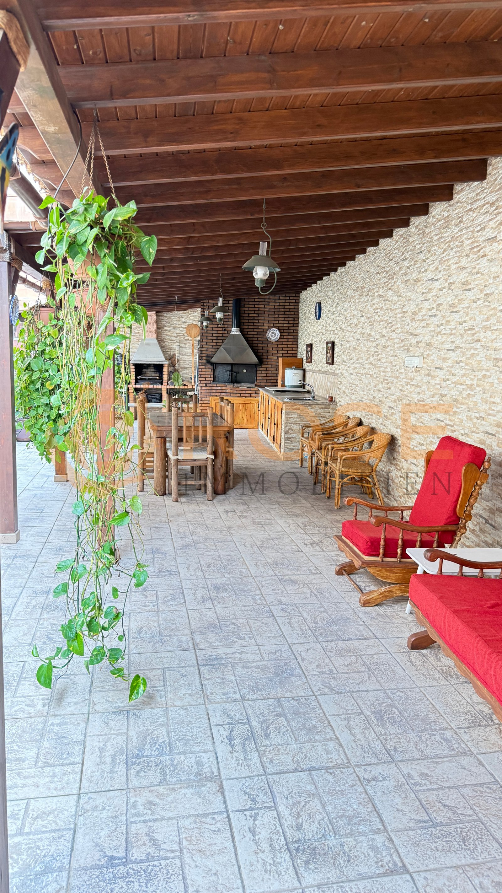 Covered outdoor kitchen with solid wood construction and integrated grill area