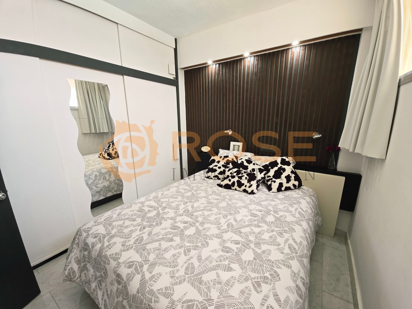 Bedroom with full-height mirrored wardrobe and high-quality blackout system Bedroom with full-height mirrored wardrobe and high-quality blackout system