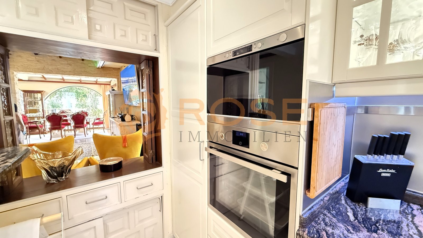 Modern kitchen with high-quality built-in appliances and open connection to the living area