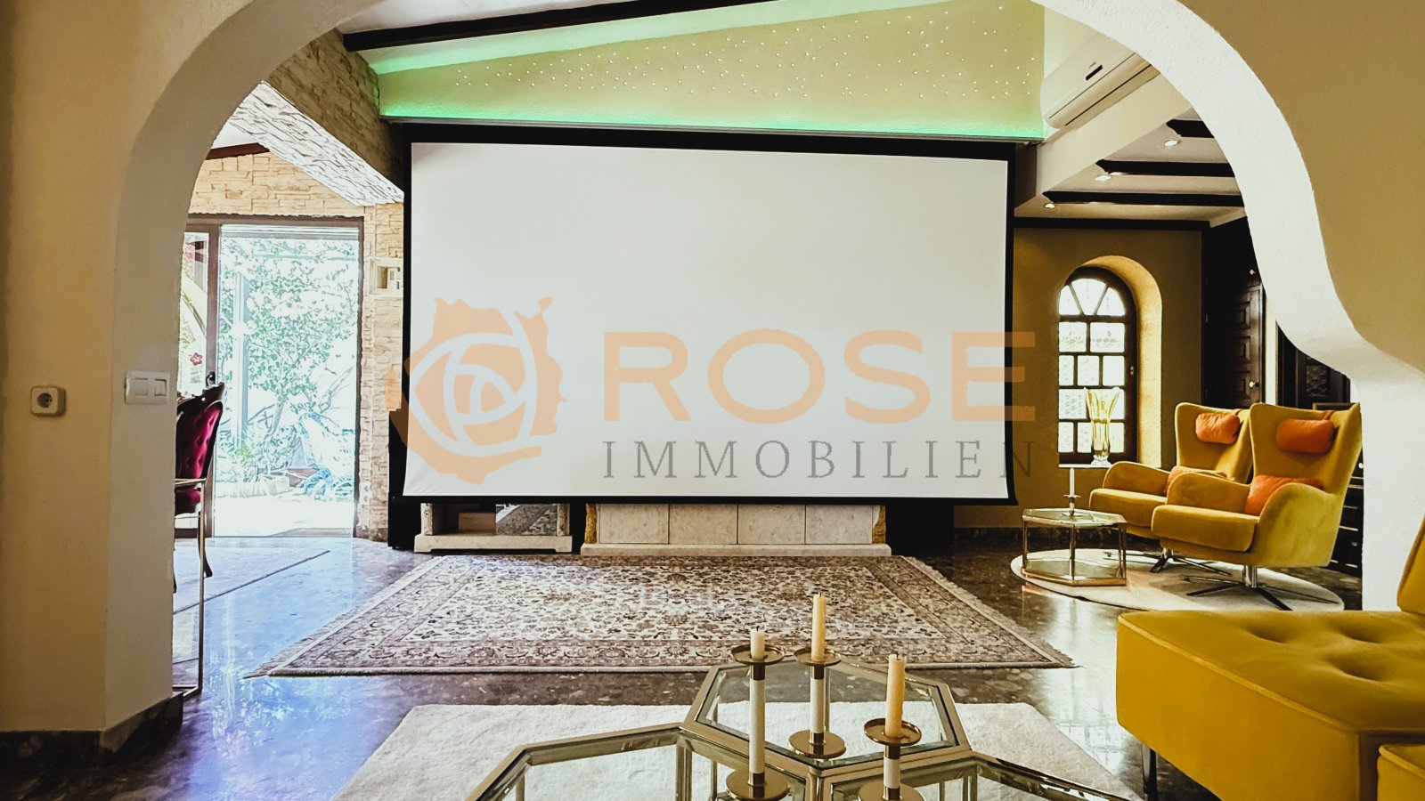 Elegant living room with projection screen and indirect ceiling lighting – perfect for entertainment and presentations