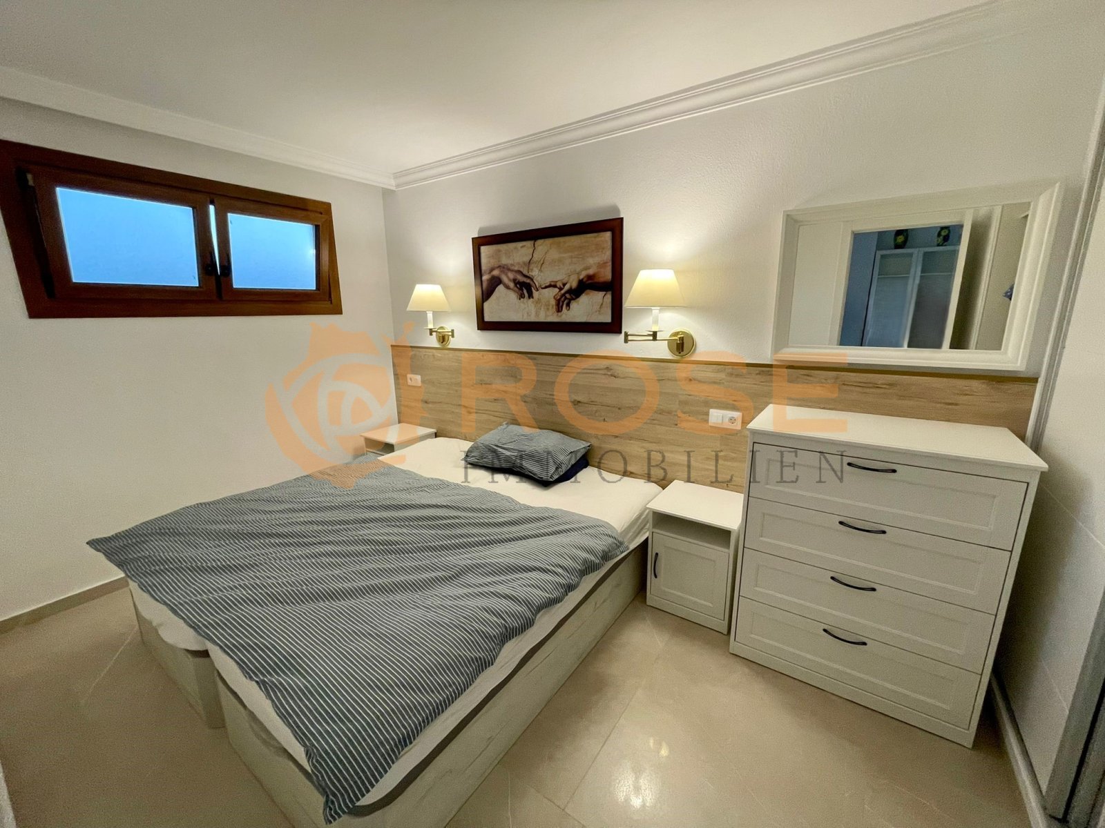 Comfortable bedroom with integrated headboard and practical storage options