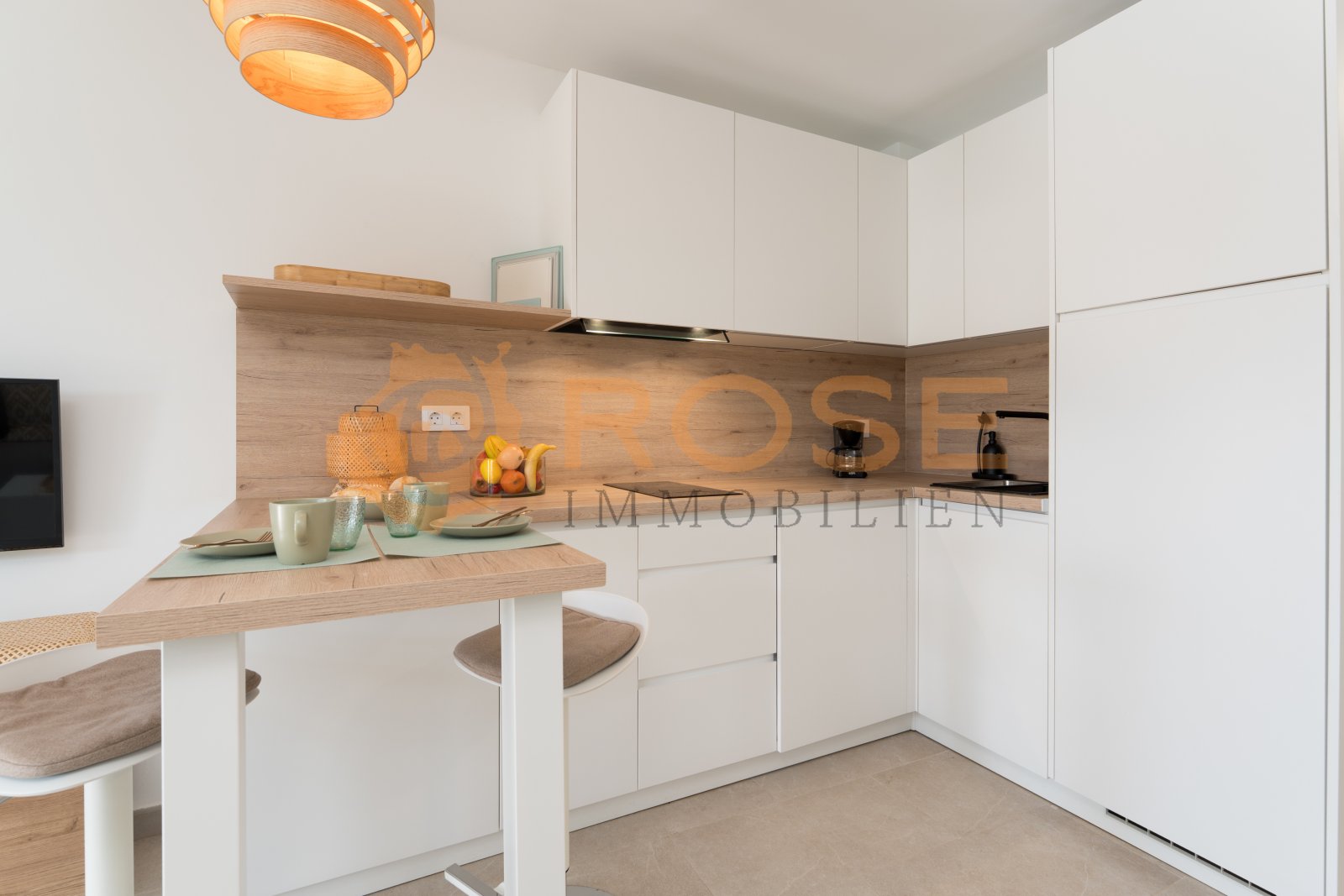 Modern kitchen with integrated cooking area, practical counter, and smart storage solution Modern kitchen with integrated cooking area, practical counter, and smart storage solution