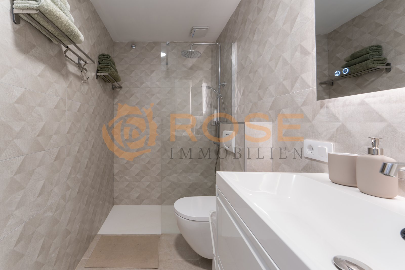 Modern bathroom with walk-in shower, double washbasin, and high-quality tiling. Modern bathroom with walk-in shower, double washbasin, and high-quality tiling.