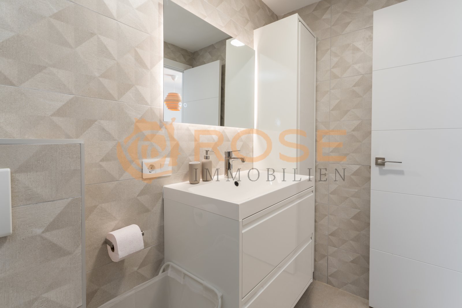 Modern bathroom with walk-in shower, vanity unit with storage, and large mirror front. Modern bathroom with walk-in shower, vanity unit with storage, and large mirror front.