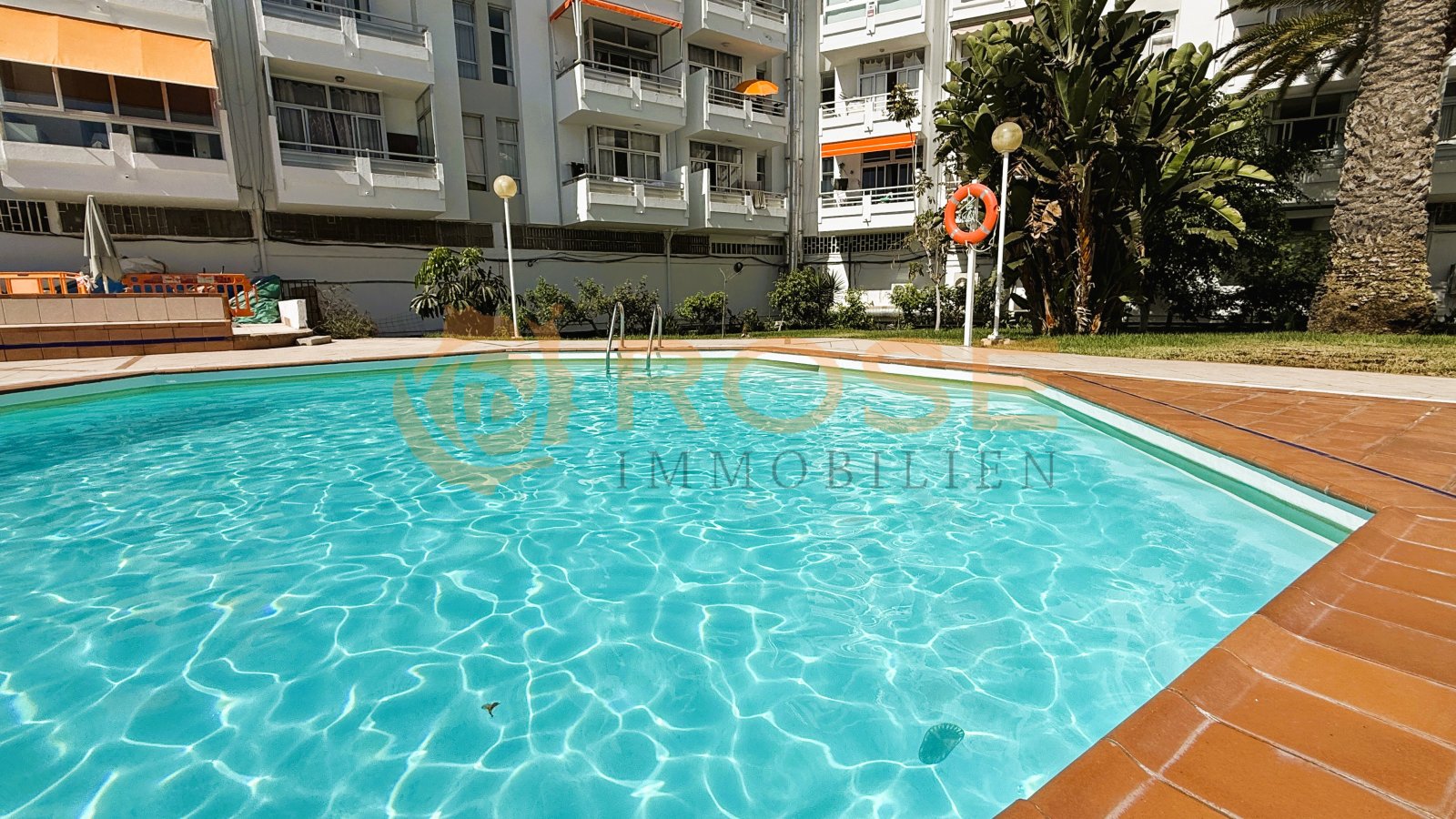 Refreshing pool area with spacious loungers and well-maintained outdoor space