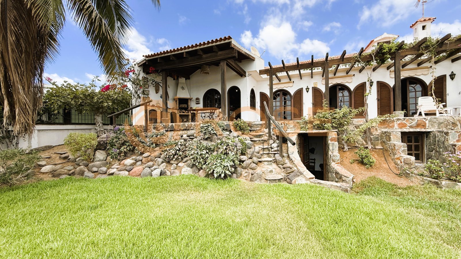 Spacious outdoor area with natural elevation changes and integrated pool landscape